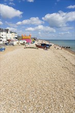 England, West Sussex, Bognor Regis, The beach pebble shingle and seafront with tourists.