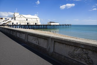 England, West Sussex, Bognor Regis, The Pier with people fishing off the end and the shingle pebble