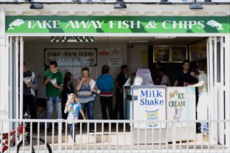 England, West Sussex, Bognor Regis, People at a Take Away Fish and Chip shop on the seafront.