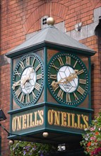 Ireland, County Dublin, Dublin City, Large green clock on the wall outside O Neils bar.
