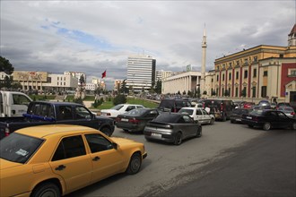 Albania, Tirane, Tirana, Congested traffic on Skanderbeg Square. Buildings include Ethem Bey Mosque