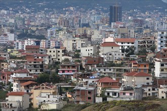 Albania, Tirane, Tirana, View across residential buildings to the hillside beyond.