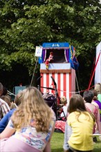 Children, Entertainment, Punch And Judy, Children sitting on grass watching the traditional puppet