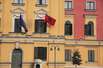 Albania, Tirane, Tirana, Part view of pink and yellow exterior facade of government buildings in