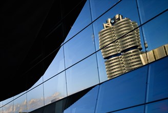 BMW Headquarters and tower reflected in glass facade of BMW Welt showroom. Photo: Hugh Rooney