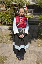 Young Naxi woman wearing traditional costume. Photo: Mel Longhurst