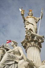 Statue of Athena raised on pillar above fountain in front of the Parliament building. Photo :