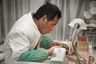 Man manufacturing a jade ornament in a jade factory. Photo: Mel Longhurst