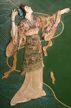 Painted jade carving of a Chinese woman on a piece of furniture. Photo : Mel Longhurst