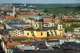 City rooftops with dome of Theatinerkirche St Kajetans Church at centre and Hofgarten on right.