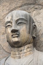 Carved Buddha statue in the Fengxian Temple Tang Dynasty Longmen Grottoes and Cave. Photo : Mel