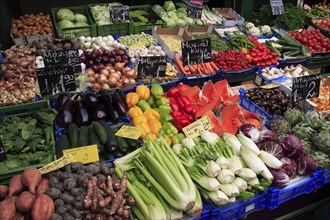 Vegetable stall in the Naschmarkt with display of produce including celery fennel aubergines and