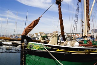 Port Solent Sailing barge SB Kitty moored in the marina with housing beyond. Photo: Paul Seheult