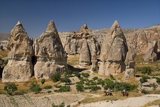 Sword Valley rock formations with horse riders in foreground. The valley got its name because of