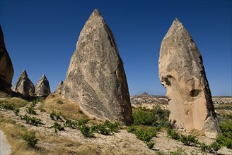 Sword Valley rock formations with hilltop town of Uchisar in distance behind. The valley got its