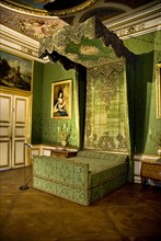 Nymphenburg Palace. Interior of the Apartment of the Electress the bedroom. Bed with green drapes