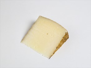Slice of Spanish Manchego cheese made from pasteurised Manchega sheeps milk from the La Mancha