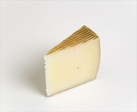 Slice of Spanish Manchego cheese made from pasteurised Manchega sheeps milk from the La Mancha