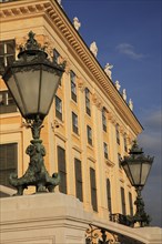 Schonnbrunn Palace. Part view of exterior facade with decorative metal lanterns on balcony in