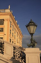 Schonnbrunn Palace. Part view of exterior facade with decorative metal lantern on balcony in