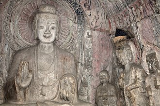 A carved stone Buddha carved from the rock Longmen Grottoes and Caves. Photo : Mel Longhurst