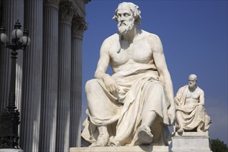 Statue of the Greek philosopher Thucydides in front of the columns to the Parliament Building.