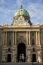 Hofburg Palace. Part view of exterior facade with domed roof above entrance archway.. Photo :