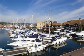 Port Solent with boats moored with restaurants a pub and housing surrounding the Marina. Photo :