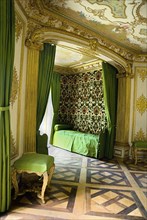 Nymphenburg Palace the Pagodenburg or bedroom. Green and gold decorated interior with day bed and