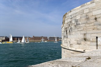 Yachts passing through the harbour entrance between HMS Dolphin in Gosport and The Round Tower in