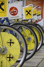 Cropped view of wheels of line of bicycles for public hire. Photo: Bennett Dean