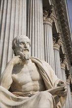 Statue of the Greek philosopher Herodotus in front of columns of the Parliament Building. Photo: