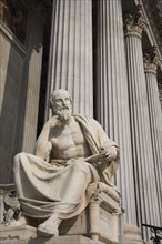 Statue of the Greek philosopher Herodotus in front of columns of the Parliament Building. Photo :