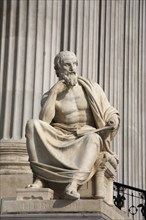Statue of the Greek philosopher Herodotus in front of columns of the Parliament Building. Photo: