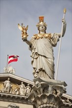 Statue of Athena raised on pillar above fountain in front of the Parliament building. Photo :