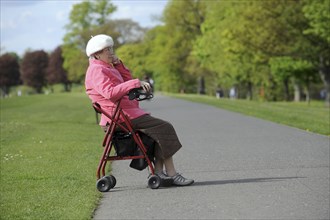 Elderly woman sat in mobility walking aid. Photo: Steve Lindridge