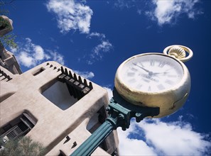 Museum with typical Adobe architecture and large clock in the foreground. Photo : Stephen Rafferty