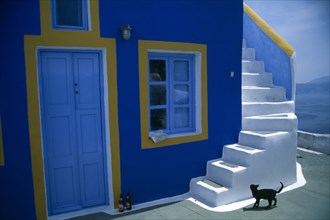 Greece, Cyclades, Santorini, Fira. Blue painted house with white steps leading up the outside wall