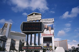 USA, Nevada, Las Vegas, Mirage hotel and casino with signs for Caesars Palace with Siegfield & Roy