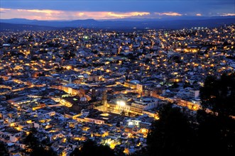 Mexico, Bajio, Zacatecas, View over city rooftops at night from Cerro de la Buffa. 
Photo : Nick