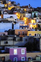 Mexico, Bajio, Zacatecas, Colourful housing across the hillside at night. 
Photo : Nick Bonetti