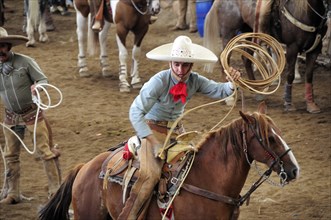 Mexico, Bajio, Zacatecas, Traditional horsemen or Charros competing in Mexican rodeo mounted rider