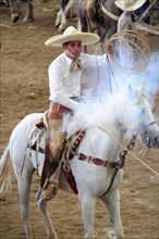 Mexico, Bajio, Zacatecas, Traditional horseman or Charro competing in Mexican rodeo holding lasso.