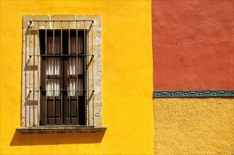 Mexico, Bajio, San Miguel de Allende, Detail of exterior wall of bright yellow and orange painted