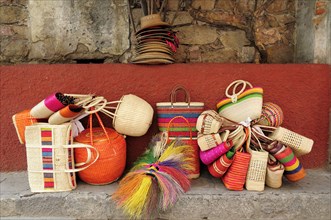 Mexico, Bajio, San Miguel de Allende, Colourful straw baskets for sale in the market. 
Photo :