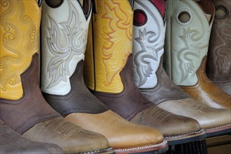 Mexico, Jalisco, Guadalajara, Line of embroidered leather boots for sale. 
Photo : Nick Bonetti