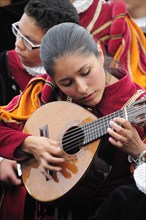 Mexico, Bajio, Guanajuato, Musician playing stringed instrument in the Jardin de la Union. 
Photo