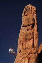 USA, Colorado, Colorado Springs, Garden of the Gods public park rock climber on pinnacle formation.