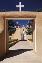 USA, New Mexico, Taos, Church of San Francisco de Asis. Entrance framing view to church exterior