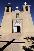 USA, New Mexico, Taos, Church of San Francisco de Asis. Exterior of church with deep shadow of